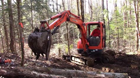 mini excavator trees|clearing trees with excavator.